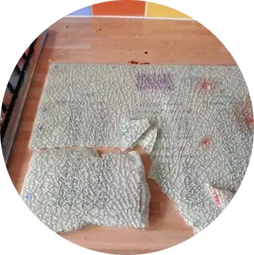 Broken glass cutting board with a heavily marked surface